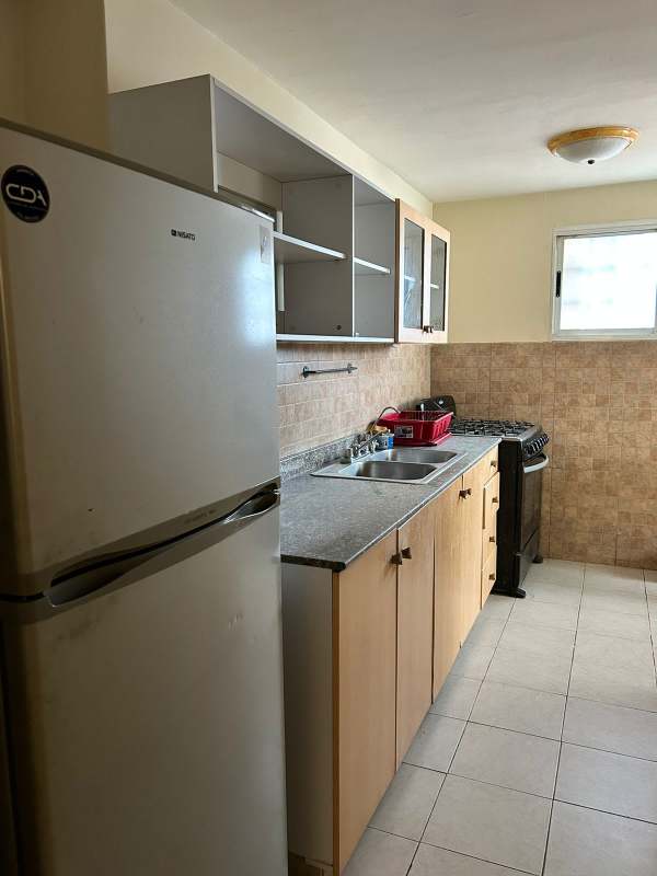 Open kitchen design with granite counters, appliances and storage cabinets in PH San Francisco Bay Panama City