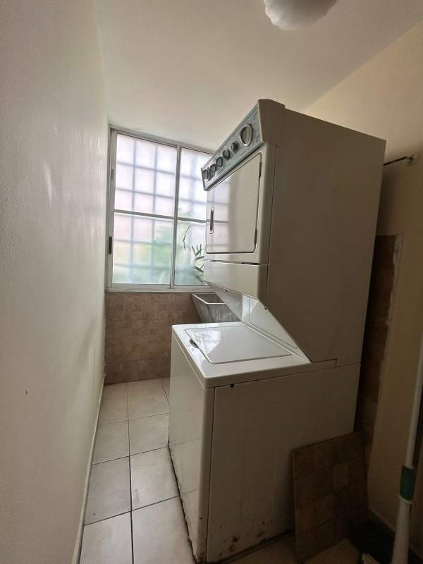 Laundry room with washer dryer hookup next to window in San Francisco Bay Panama City Panama