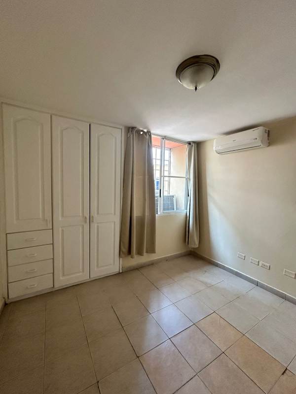 Bedroom with AC unit, closet, window, tiled floor in San Francisco Bay apartment Panama