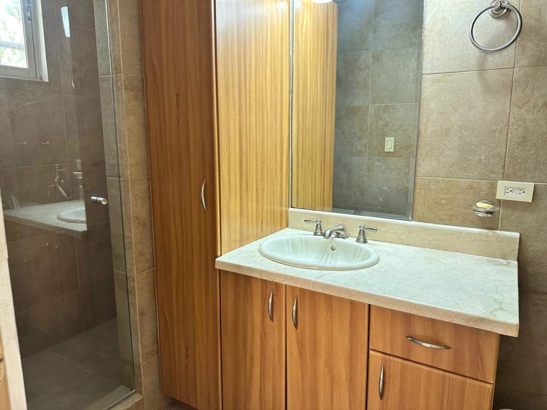 Covered garden terrace with ceiling fan at Embassy Gardens house in Clayton Panama