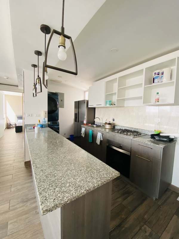 Spacious living room with dining area and city view in PH Avión Towers Condado del Rey