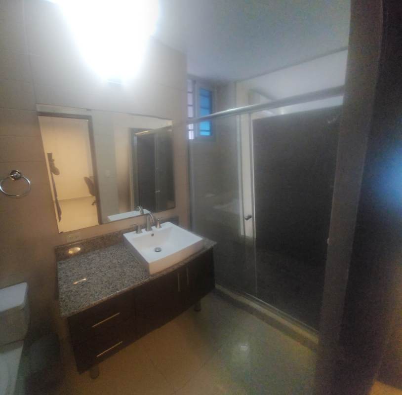 Open kitchen with granite counters and dining in furnished loft at The Gray El Cangrejo Panama