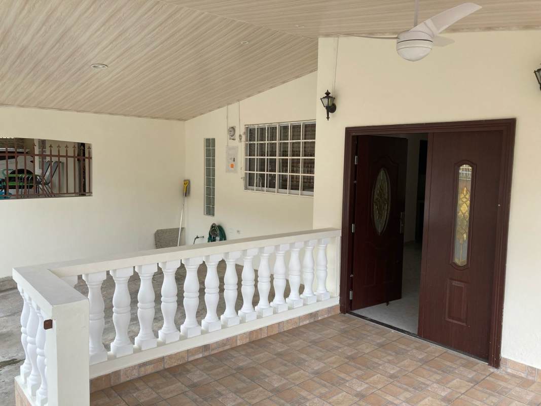 Covered porch with ceiling fan, tiled floors, decorative railing at Vista del Valle Villa Lucre house