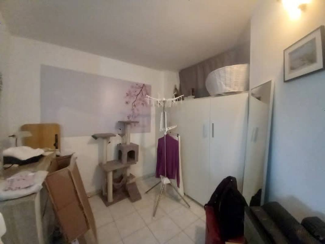 Compact living room with ceramic floors, white walls, window in Carrasquilla apartment Panama