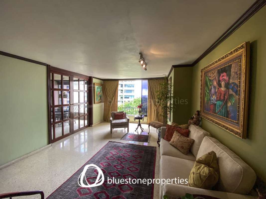 Living room area with large windows and balcony access renovated apartment PH Costa Azul Panama City