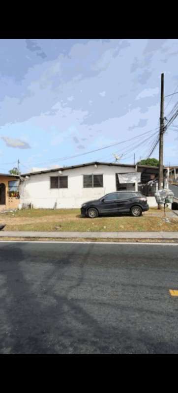 View of fenced one-story home with driveway and car parked in Monte Oscuro Panama for sale