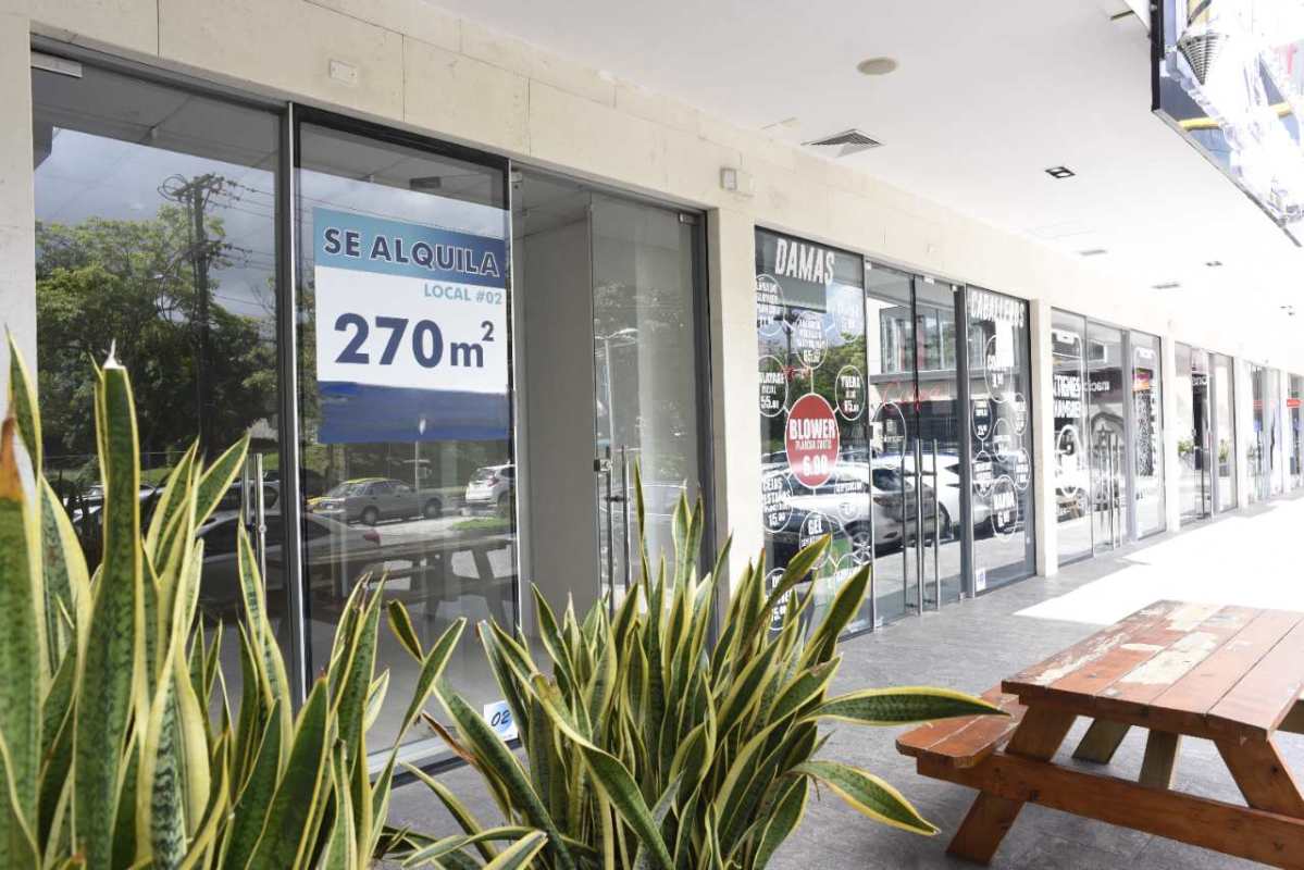 Contemporary balcony with glass railing overlooking urban street from Plaza El Cangrejo