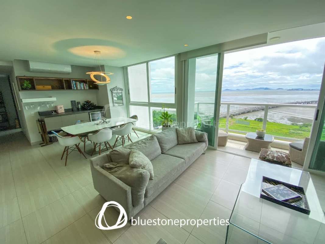 Living room open plan with large windows and Pacific Ocean views at Costa del Este condo sale Hola Realty