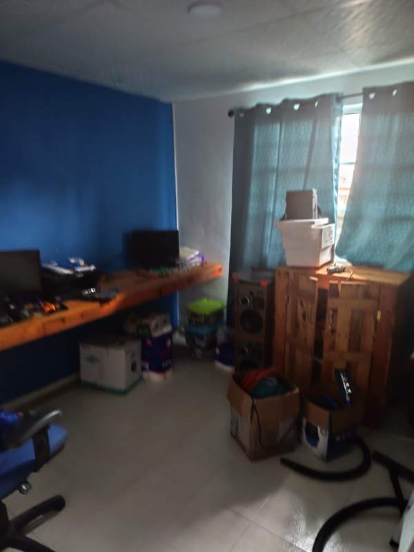 Bright home office with blue wall desk window Las Cumbres house