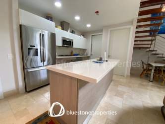 Covered terrace with outdoor seating and garden golf view in Buenaventura Panama luxury resort community