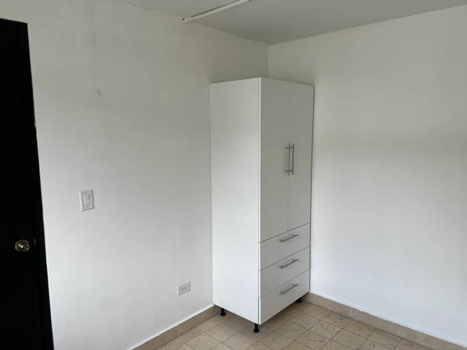 Minimalist bedroom with built-in wardrobe and tile floors Via España Panama