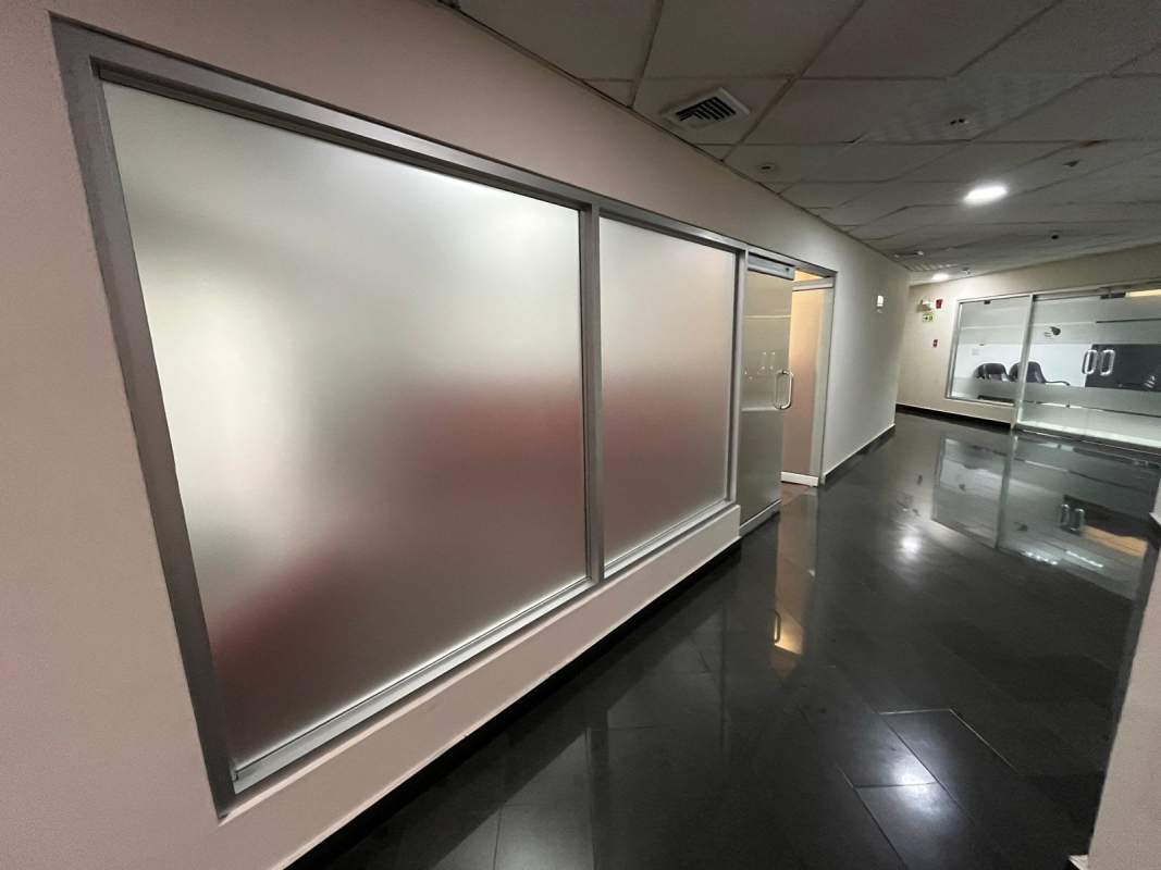 Interior view of unfurnished office for rent with wooden floors and glass partitions in PH Ocean Business Plaza Marbella