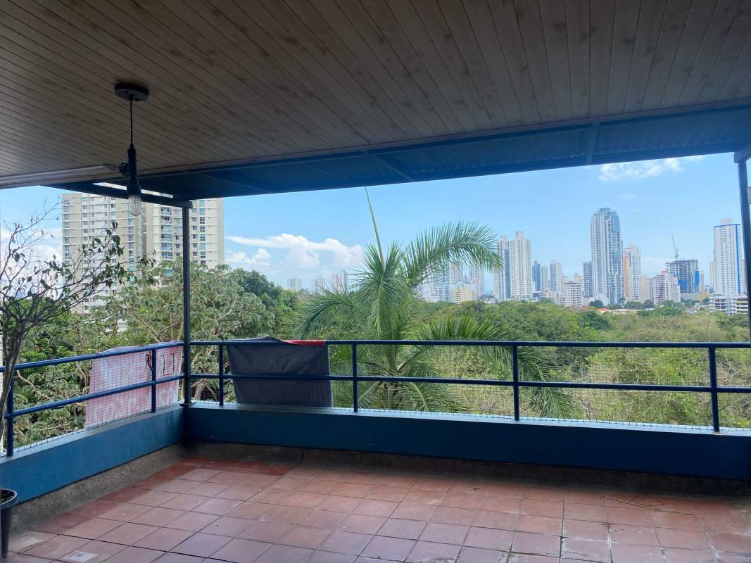 Covered terrace with tiled flooring, metal railing, overlooking Parque Omar PH Lomas del Parque Panama