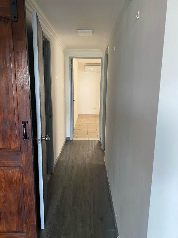 Narrow hallway with mixed laminate and tile flooring leading to rooms, PH Lomas del Parque Panama