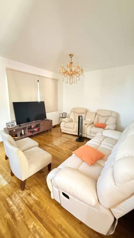 Bright living room with recliners, vaulted ceiling, TV area in Versalles Costa Sur house