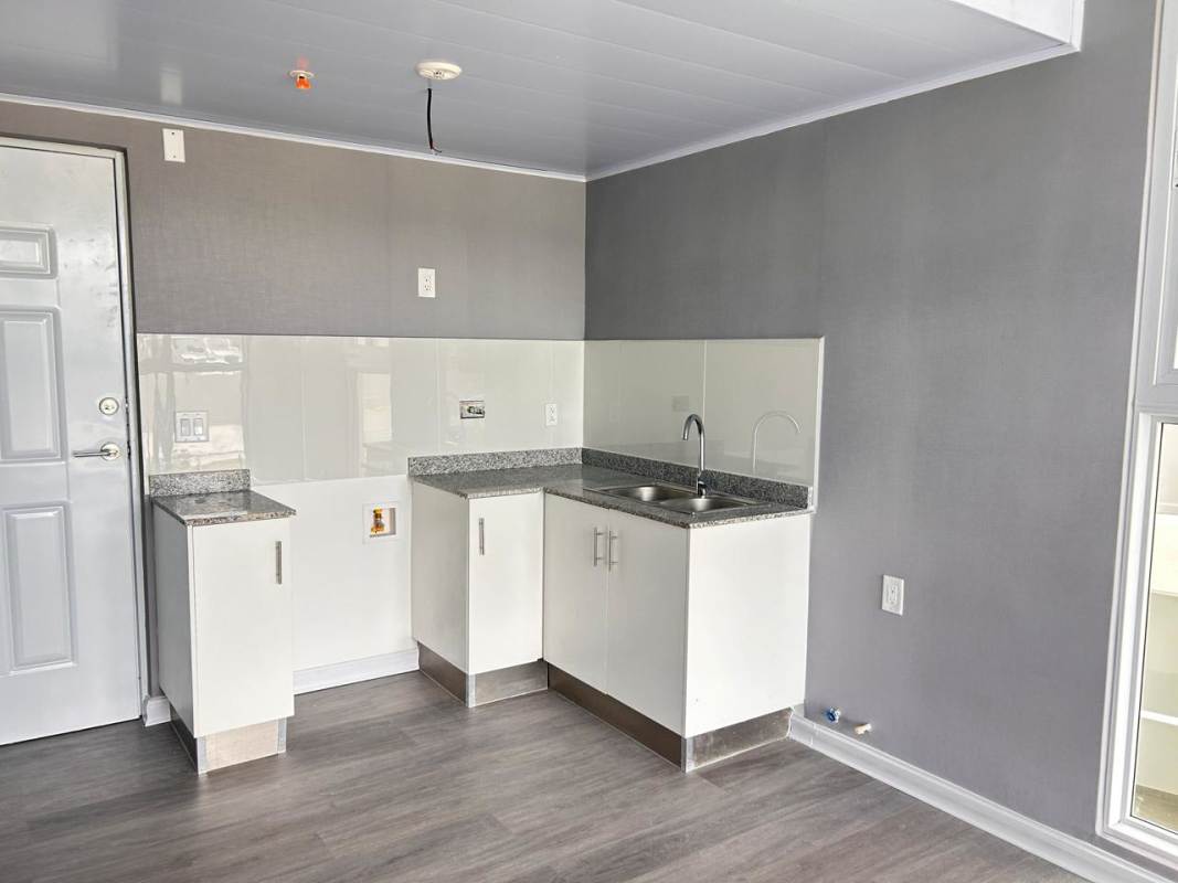 Modern compact kitchen with granite counter and tile backsplash PH Amitie Panama