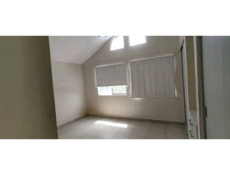 Empty bedroom with window blinds, closet, minimalist style in Playa Dorada house for rent