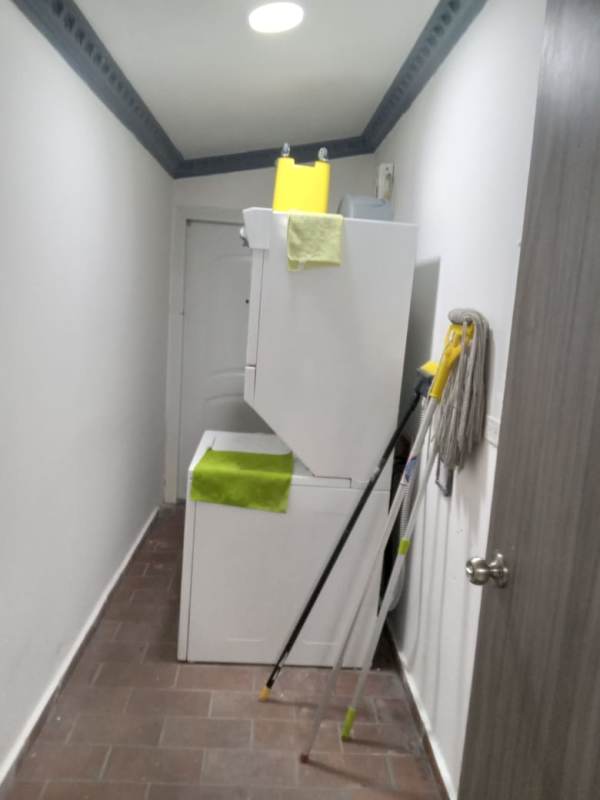 Laundry with stacked washer and dryer in Condado del Rey house