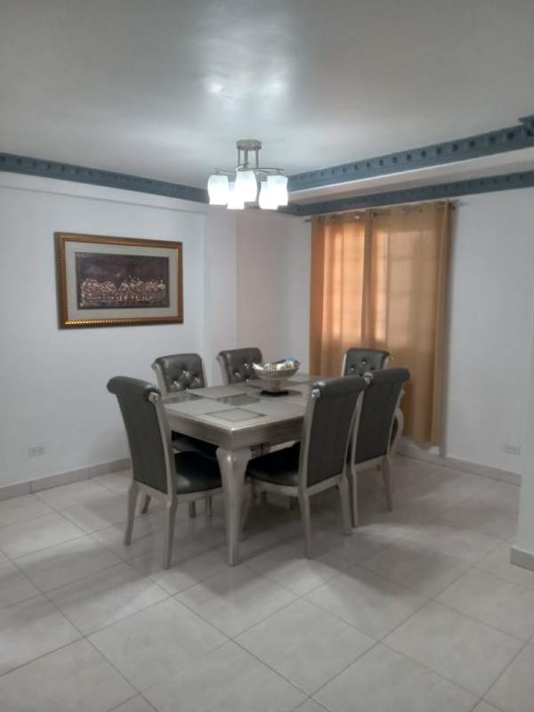 Dining room with table and upholstered chairs in Condado del Rey property