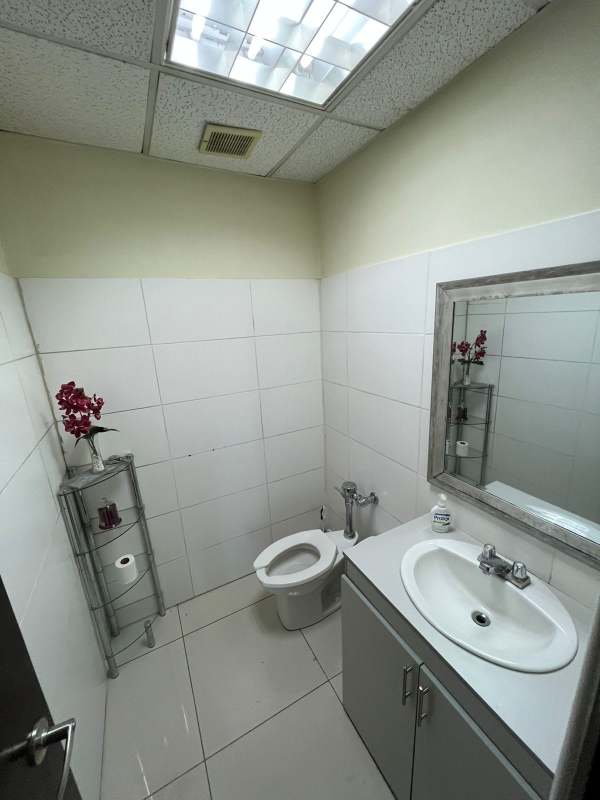 Minimalist bathroom with white tiles in PH Financial Park office Costa del Este Panama