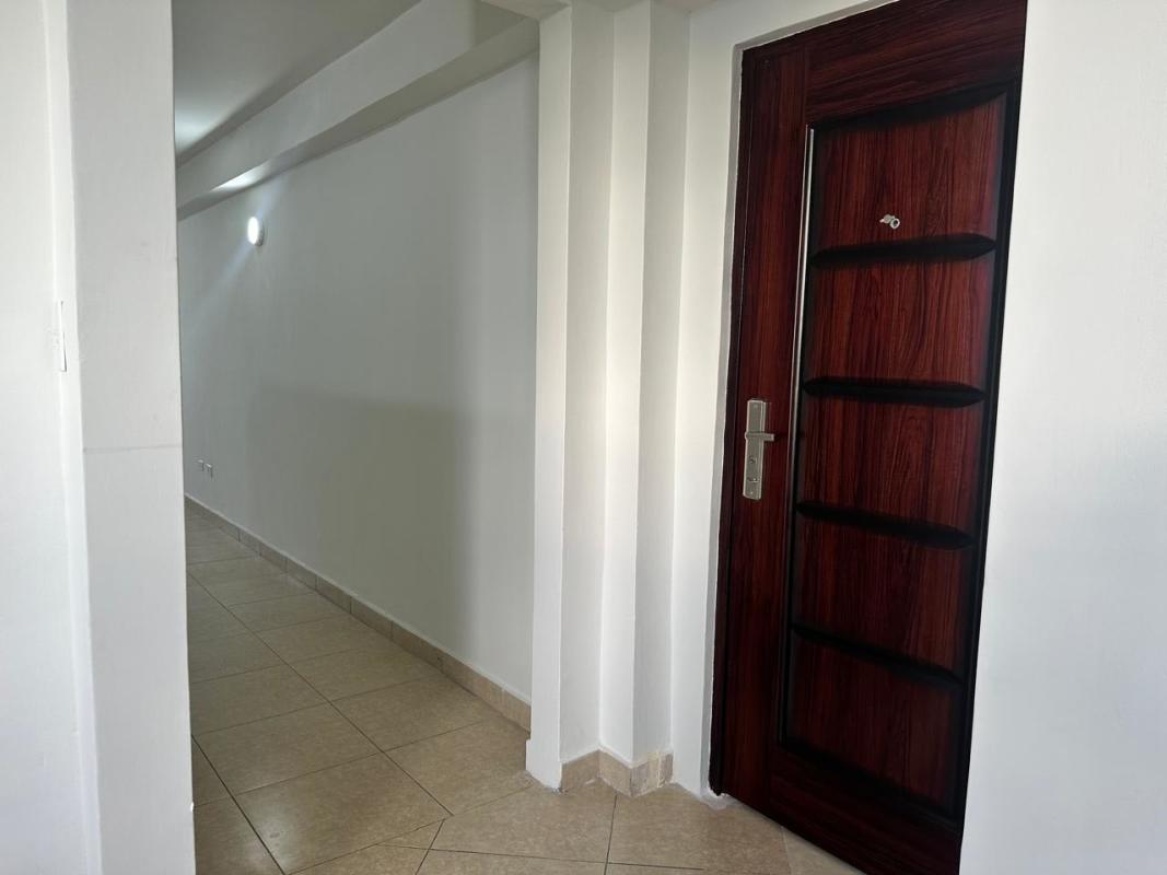 Modern entry hallway with ceramic floor tile in PH Bella Vista Garden apartment