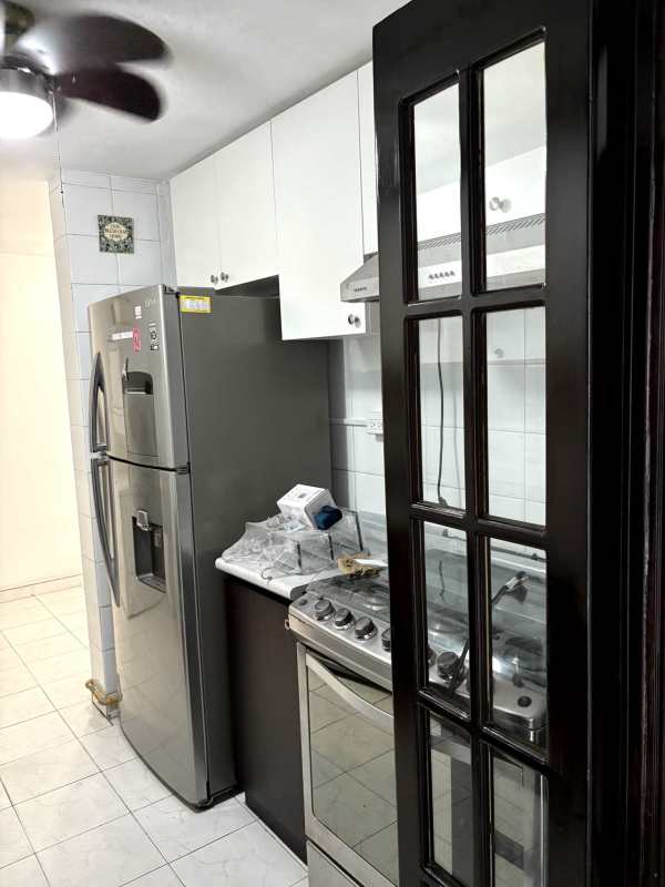 Small bathroom with glass shower door and white tiles in PH El Dorado Panama