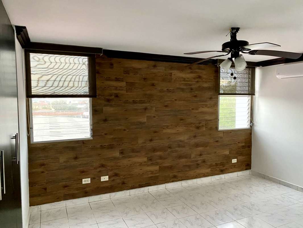 Bedroom with wood accent wall, AC ready, tile floor Panama City