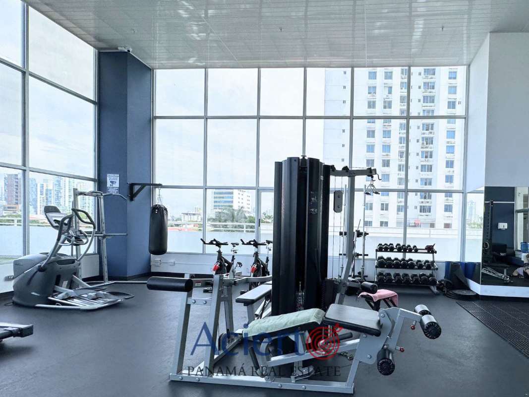 Fully equipped gym overlooking city in San Francisco Diamond Tower Panama