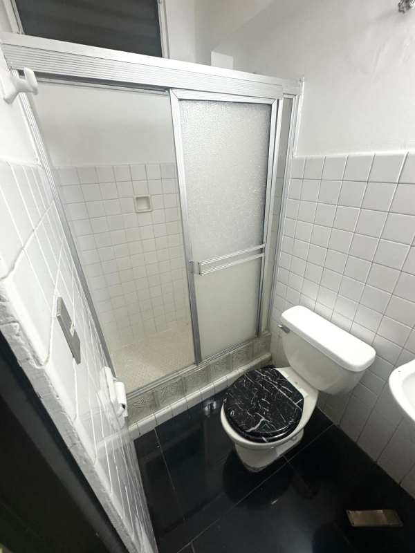 Large bright living dining room with glossy black tile floors, windows, and decorative wall panels in PH Altamira Residences