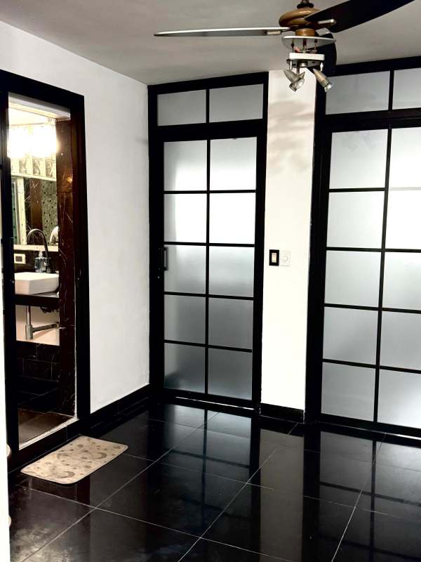 Contemporary kitchen with granite island, dark cabinets, pendant lighting at PH Altamira El Cangrejo Panama