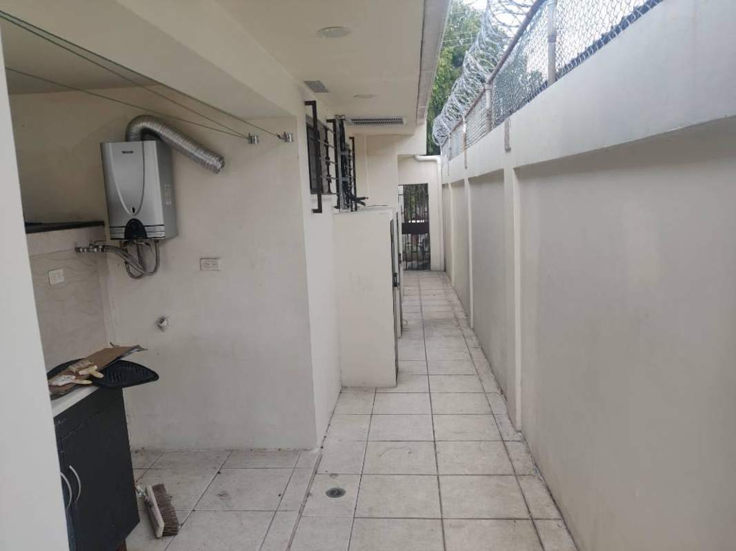 Enclosed outdoor laundry and service zone with fencing and water heater Villa de las Fuentes Panama