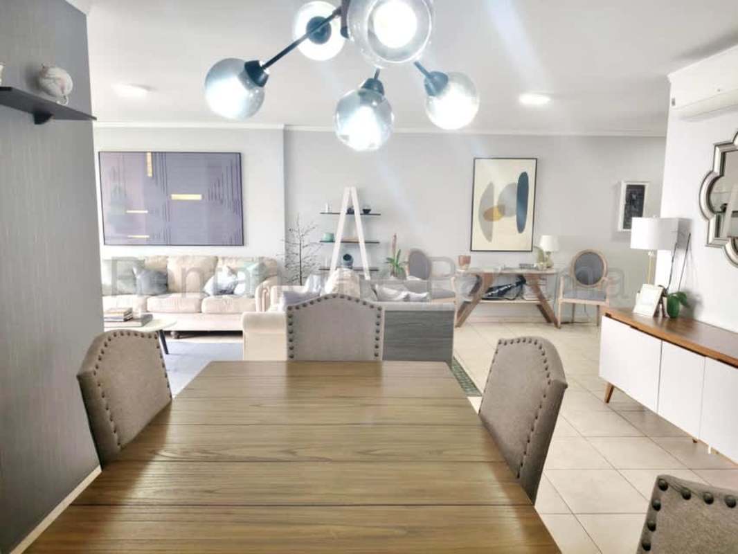 Contemporary living and dining room with neutral decor and AC in Punta Pacifica apartment rentals
