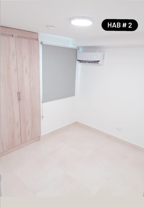Bright bedroom built-in wardrobe AC modern minimalist rental apartment Panama Viejo Residences Panama