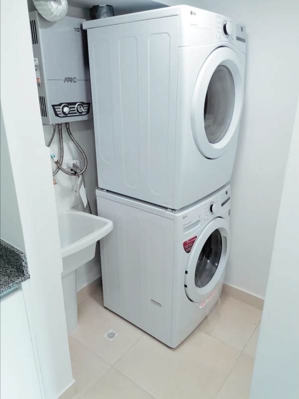 Compact laundry space with stacked washer dryer utility sink rental apartment PH Panama Viejo Panama