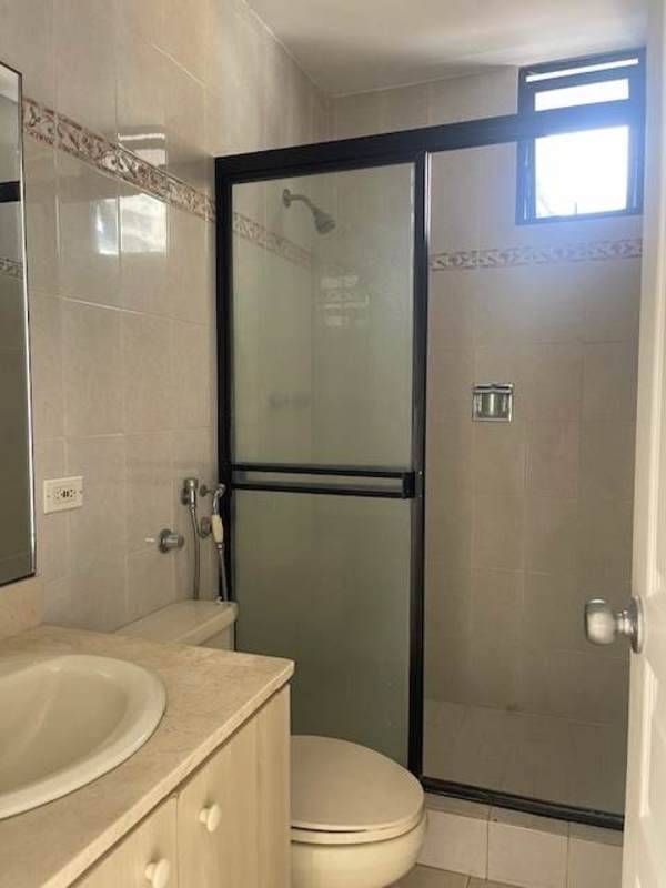 Modern bathroom with glass shower, beige tiles and vanity at PH Plaza Real Panama
