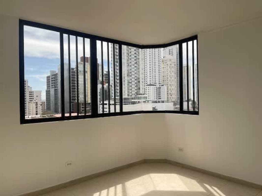 Empty room with large windows showcasing Panama skyline at PH Plaza Real San Francisco
