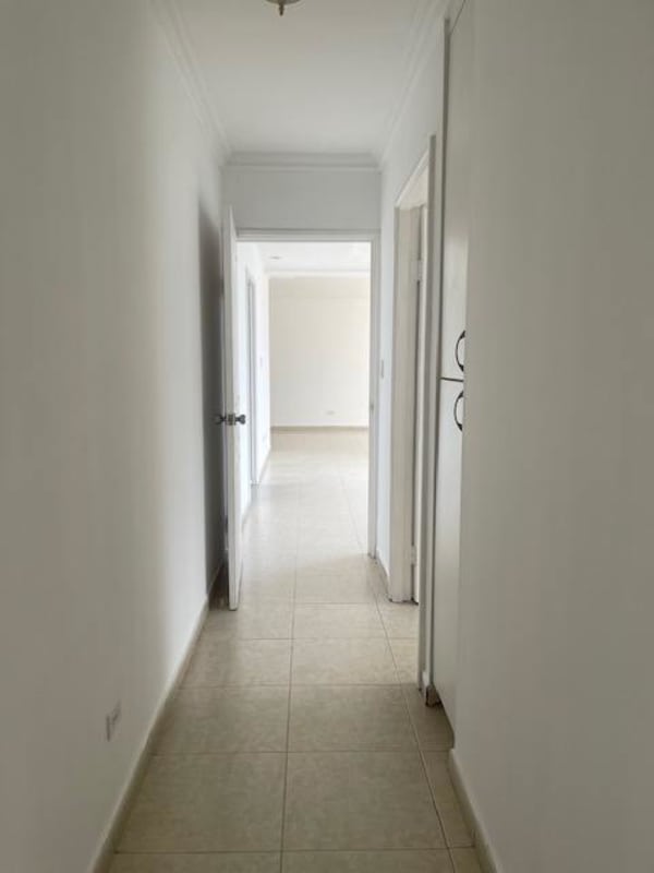 Clean white hallway with built-in cabinets leading to bedrooms in PH Plaza Real San Francisco Panama
