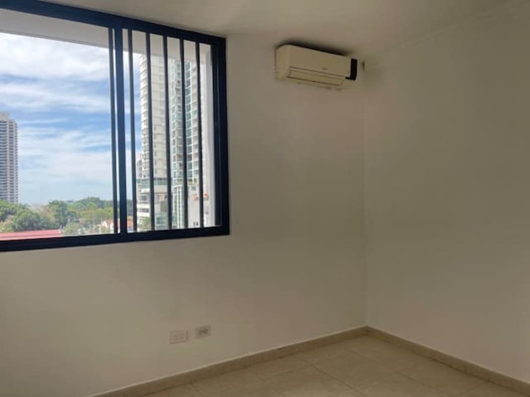 Bedroom with tiled floors, large window, AC unit in PH Plaza Real Panama