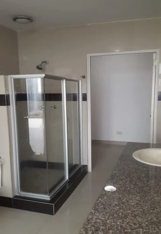 Bathroom granite countertop and glass shower at PH Privé Panama