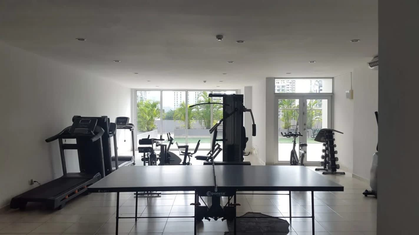 Modern gym with equipment and large windows PH Privé Panama