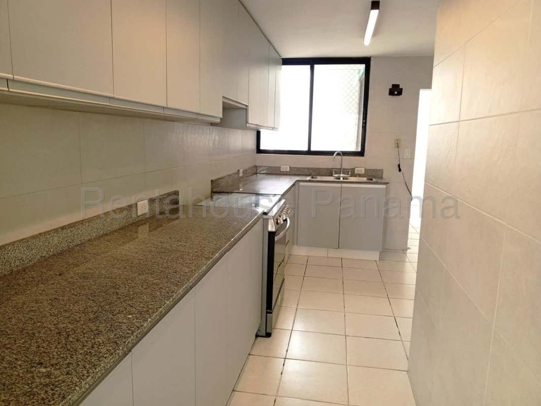 Spacious bedroom featuring large windows, closet and private bathroom in Marbella Panama apartment