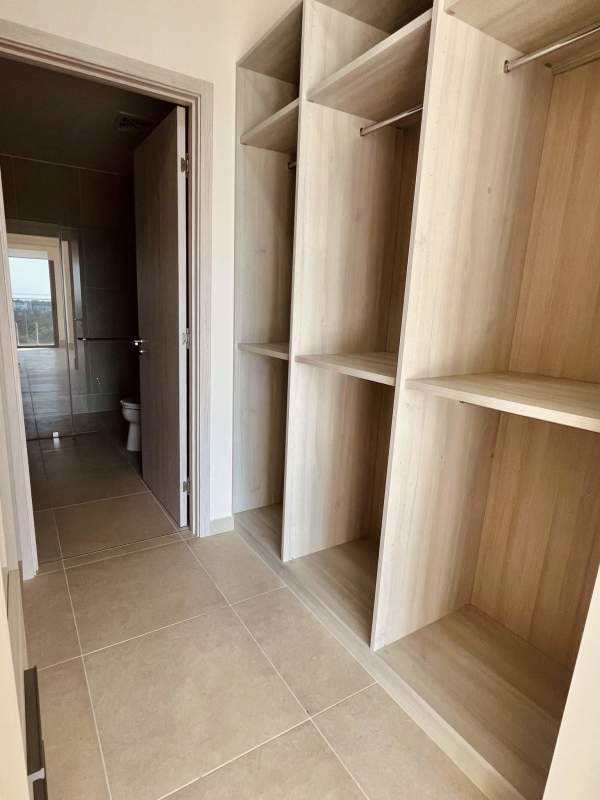 Elegant master bedroom with panoramic windows overlooking golf in Ocean House Panama City