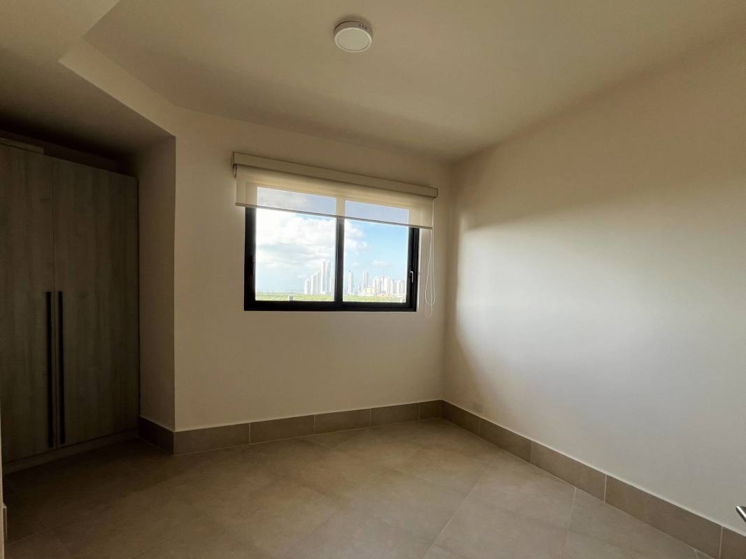 Bright second bedroom with large window overlooking golf course and ocean in Ocean House Santa Maria Panama