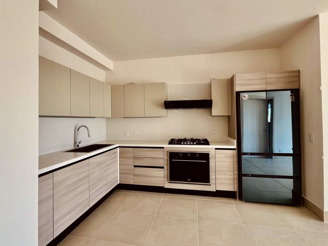 Contemporary kitchen with built-in appliances and cabinetry in Ocean House Santa Maria Panama luxury apartment