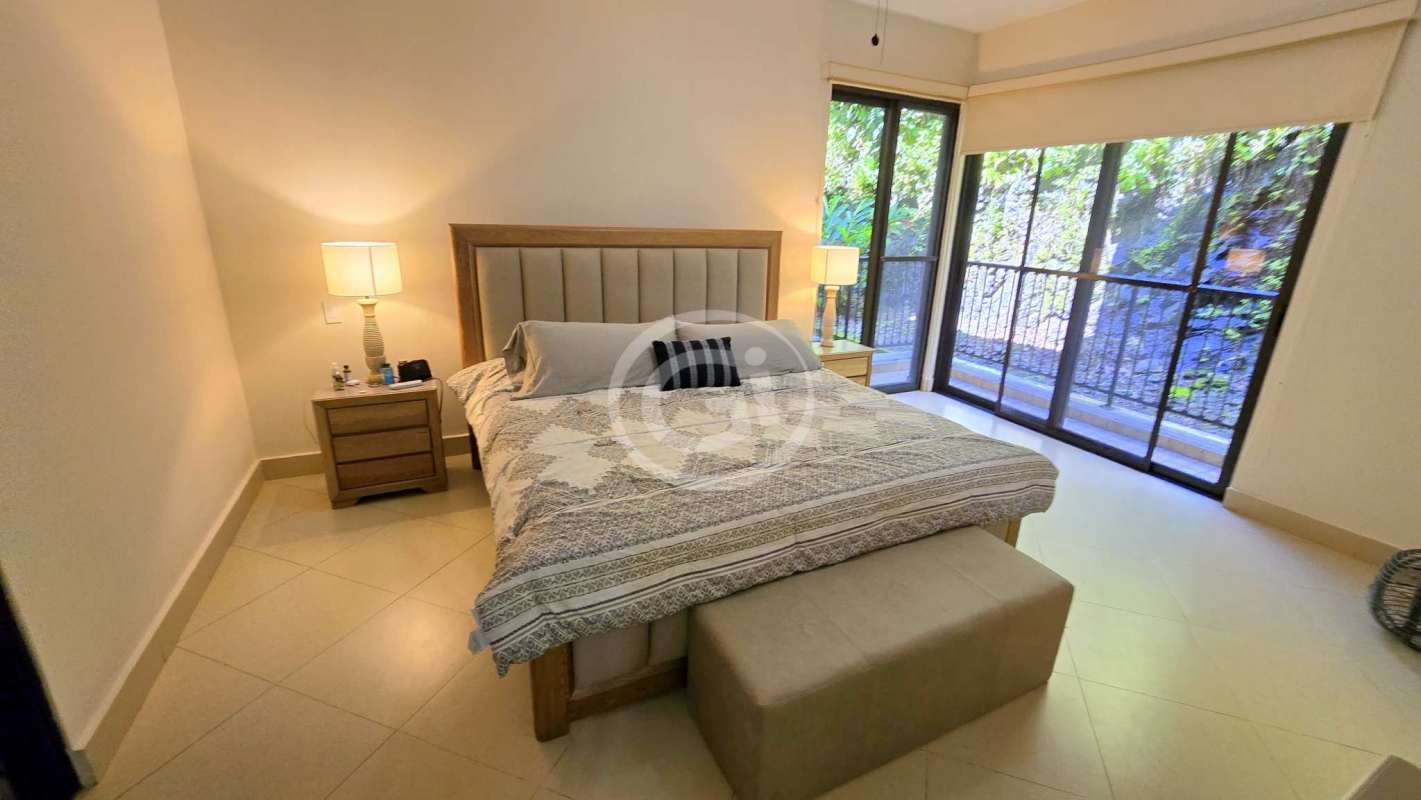 Bright living room opening onto private garden Embassy Club Clayton Panama luxury