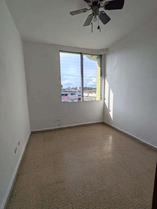 Bedroom with tiled floors ceiling fan and city view window PH Don David Panama