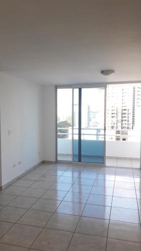 Compact kitchen with granite counters and wood cabinets at PH Taurus Tower Panama