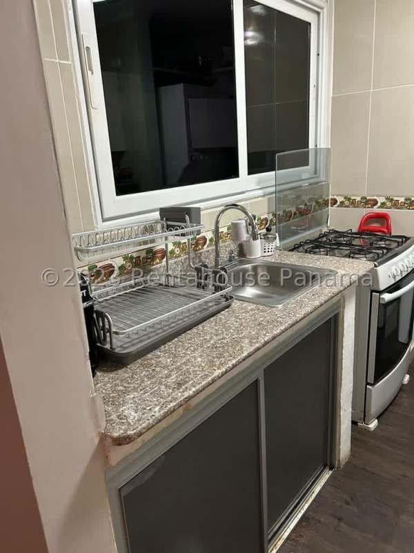 Compact kitchen white cabinets granite countertop refrigerator Mystic Tower Panama