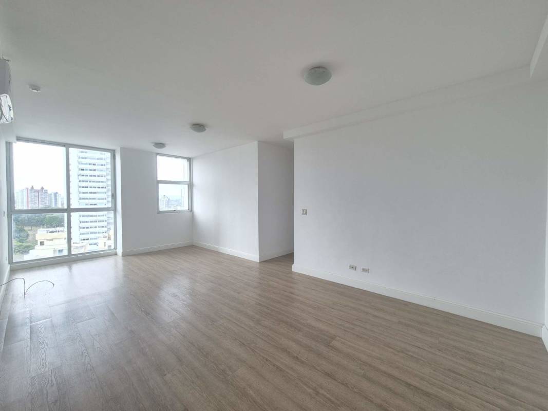Modern living room with large windows and city skyline views at PH Latorraca San Francisco Panama