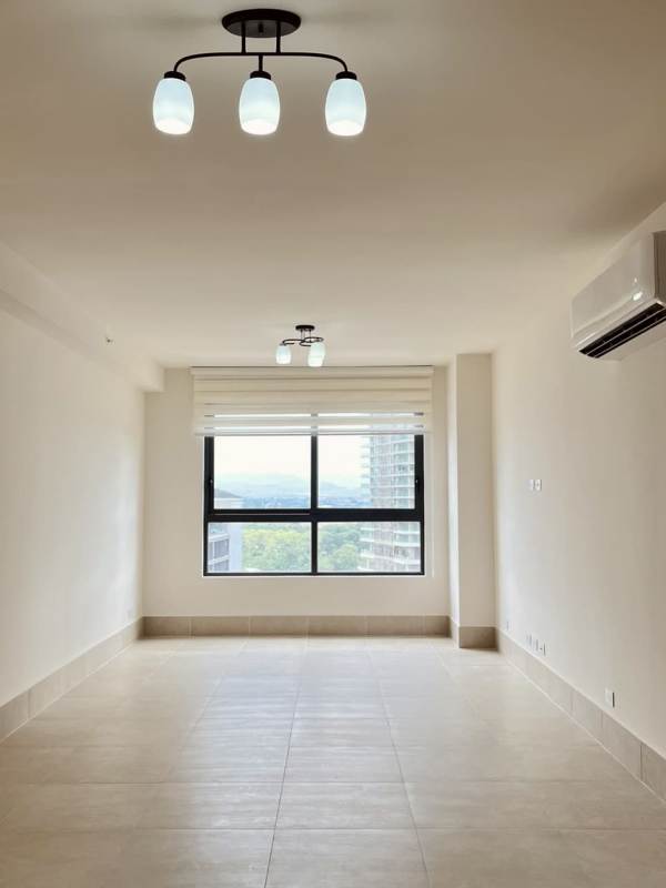 Spacious living area with natural light, tiled floor, large window and AC at Ocean House Santa Maria